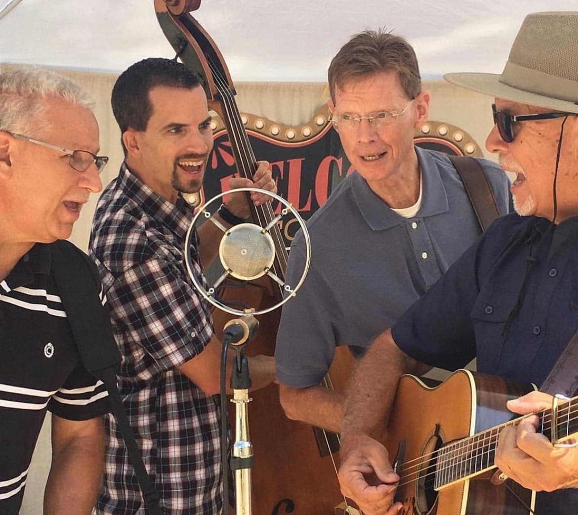 Bluegrass band performing outdoors at farm festival, live music