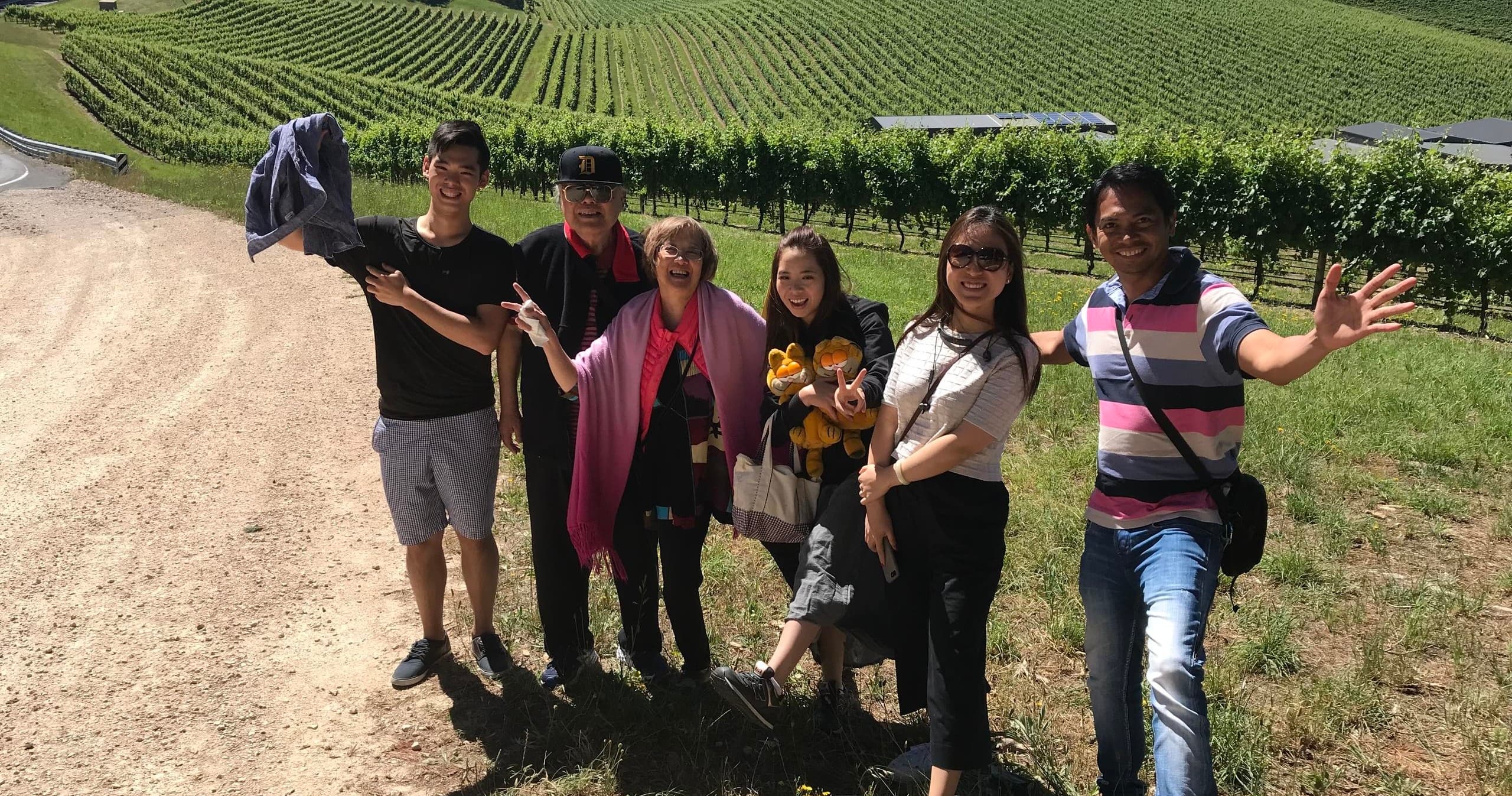Group exploring vineyard rows during guided wine tour outdoors