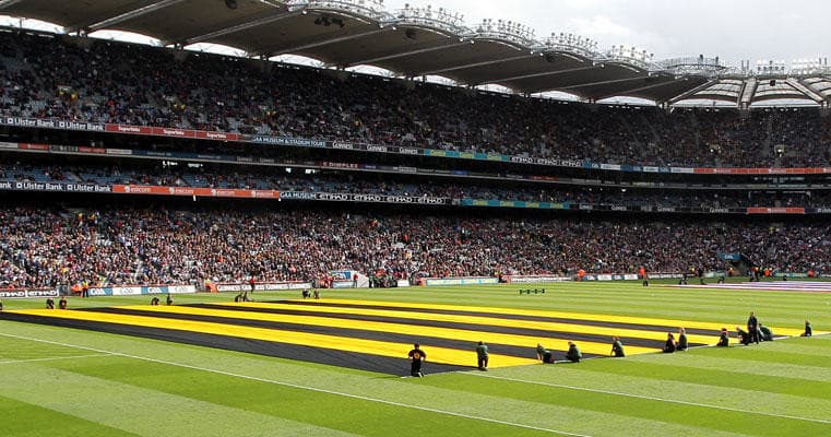 Spectators watching hurling match on Croke Park stadium pitch