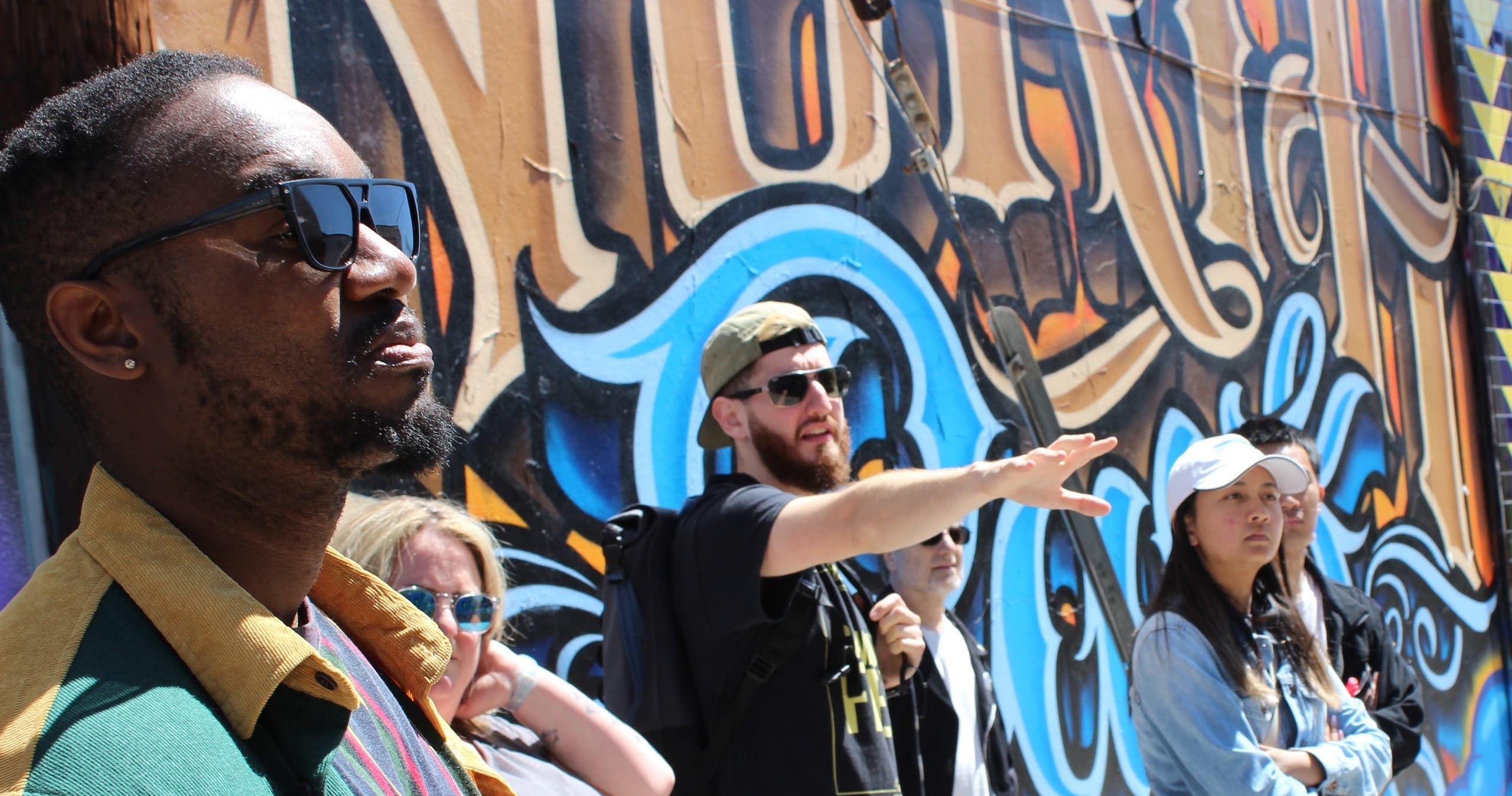 Group on urban graffiti walking tour in San Diego neighborhood