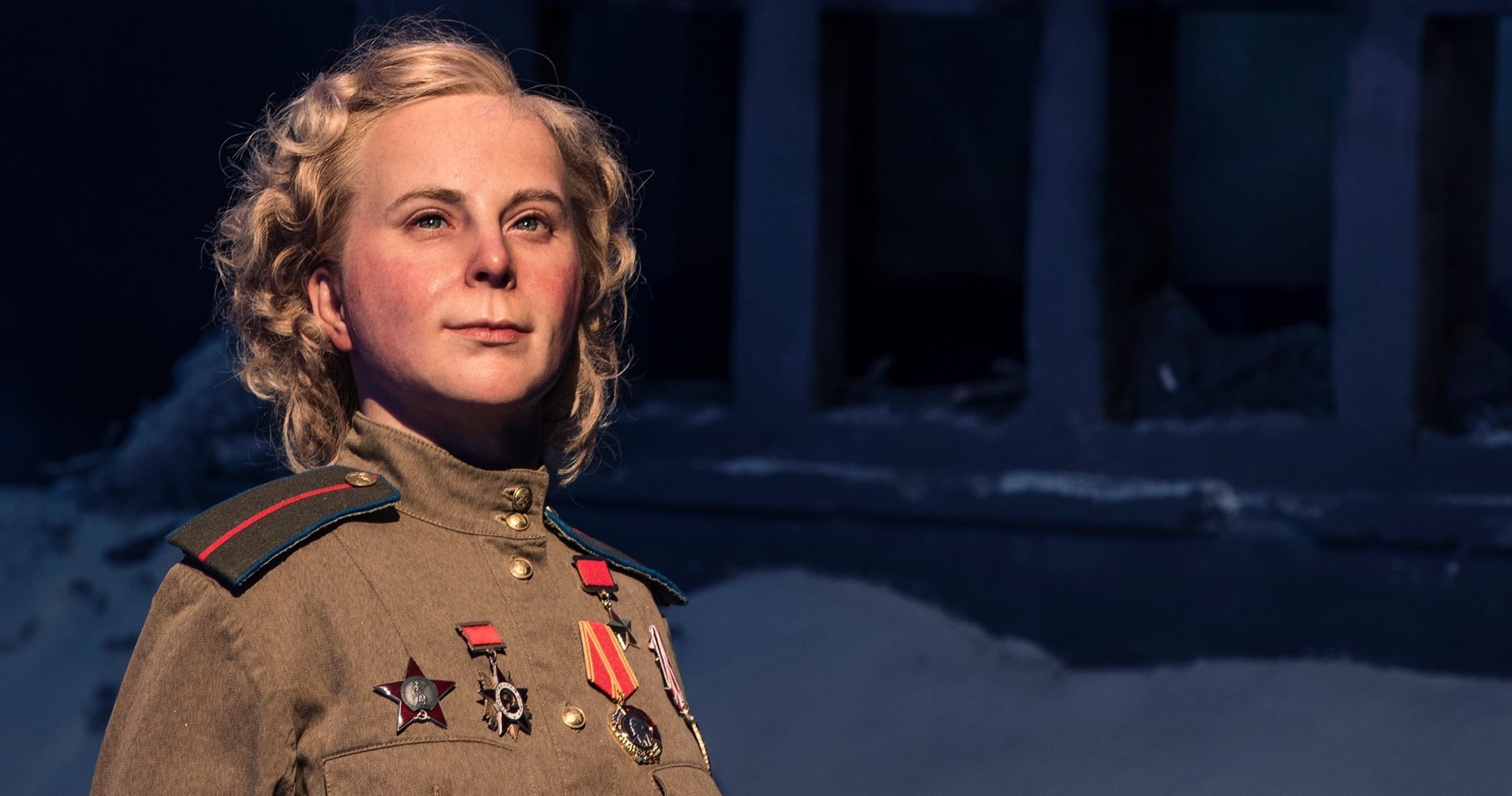 Museum exhibit: uniformed WWII-era soldier portrait in display