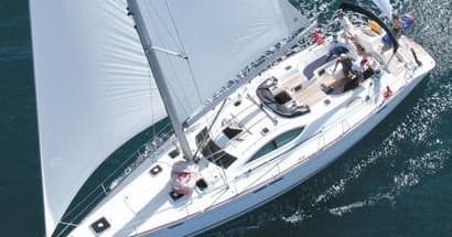 Aerial deck shot of sailboat underway on deep blue ocean waters