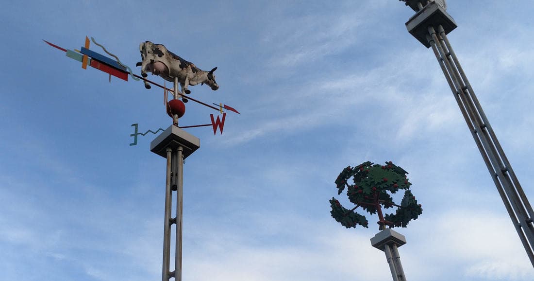 Weather vane and sky over Somerville streets, outdoor landmark