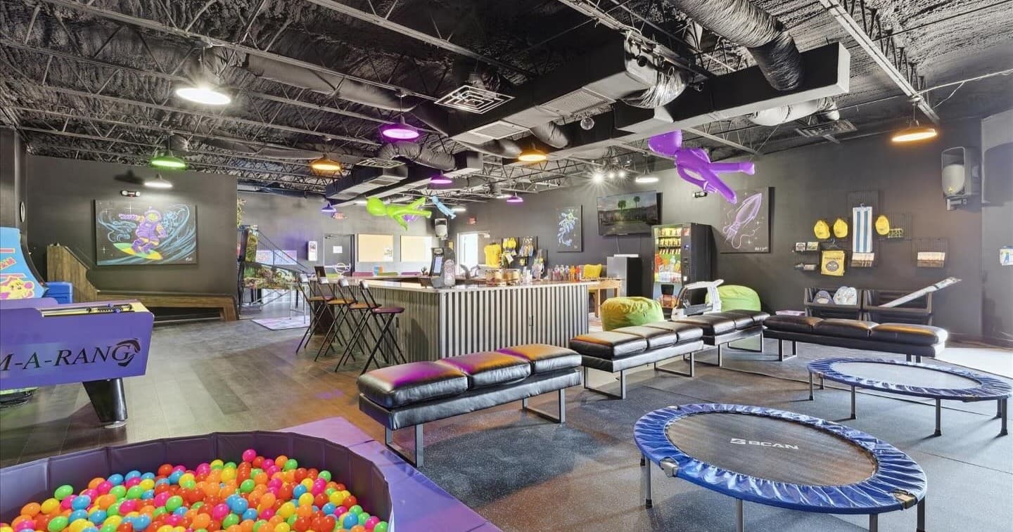 Indoor trampoline park with ball pit and lounge seating