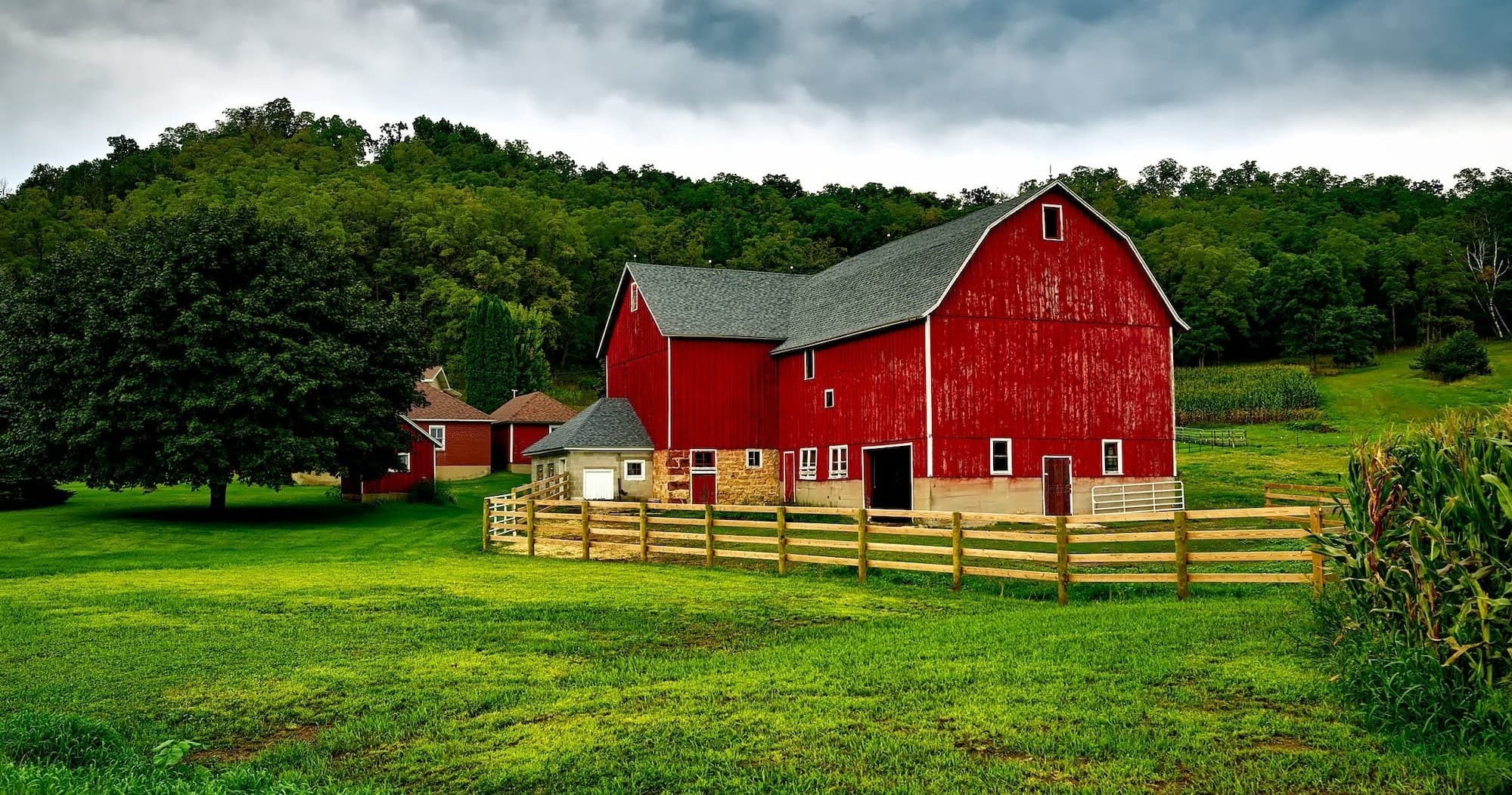 Red barn on ranch meadow showcasing scenic rural farm stay experience
