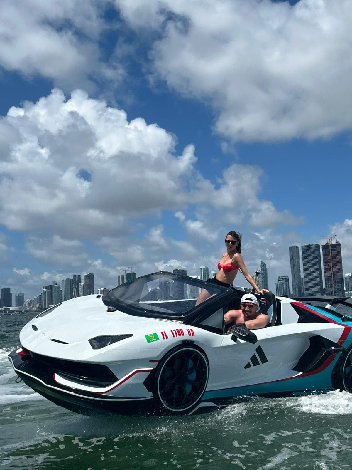 Convertible sportsboat cruising Biscayne Bay with skyline views