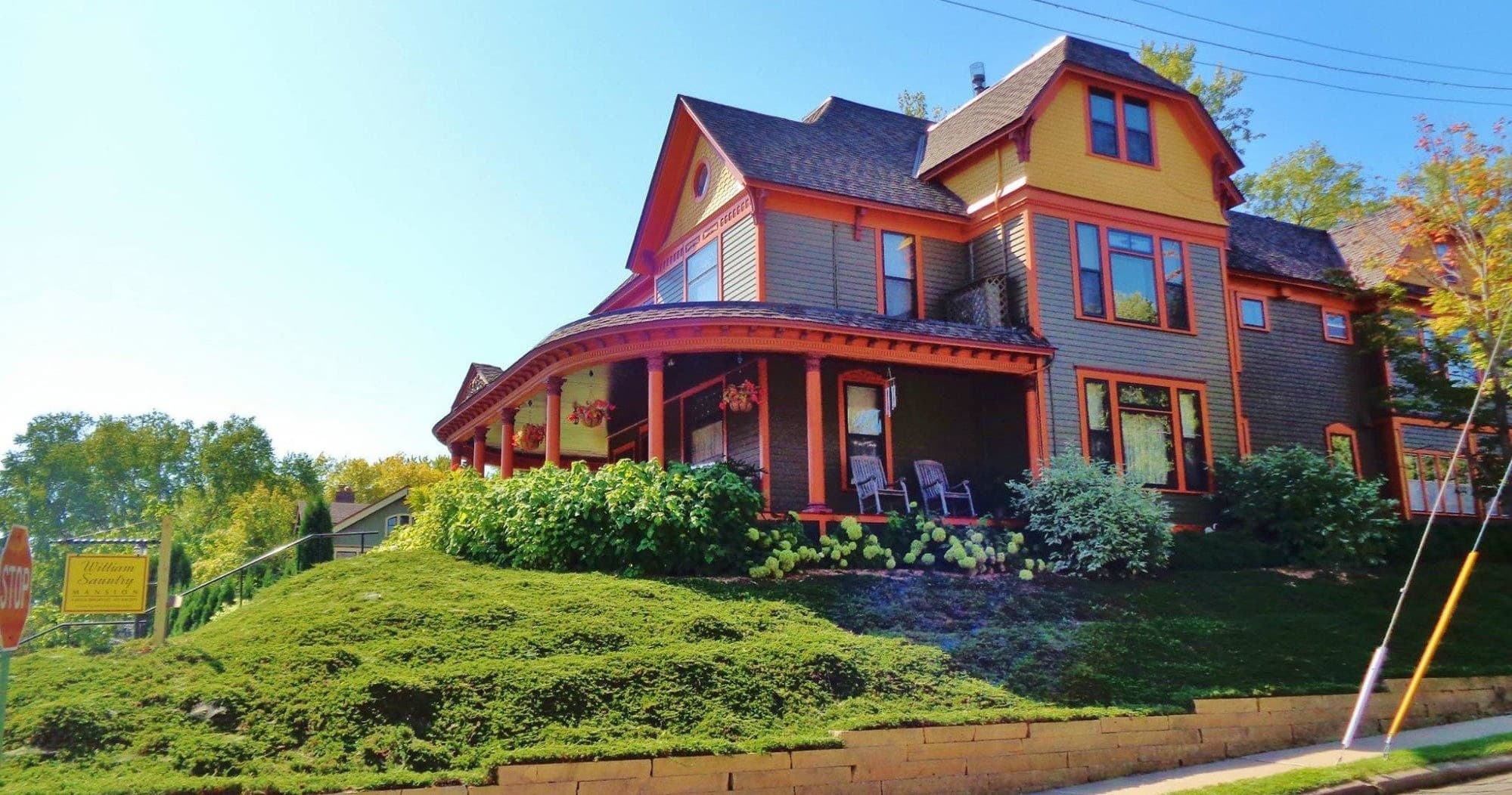 Historic Victorian house on sunny hill, scenic neighborhood view
