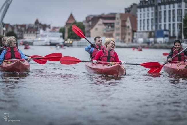 Multiple kayakers paddling on urban river tour in Gdansk
