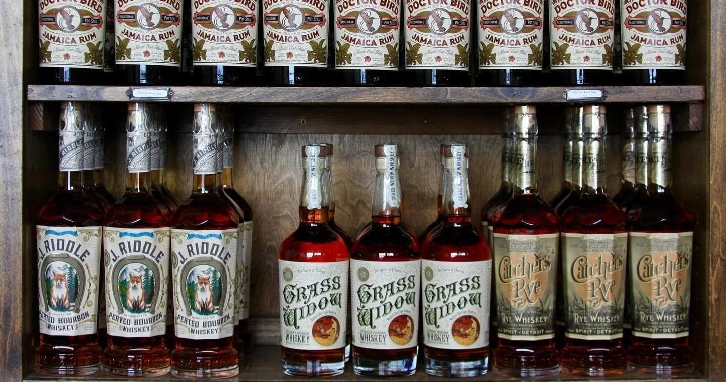 Two James whiskey bottle lineup on wooden shelf in tasting room display