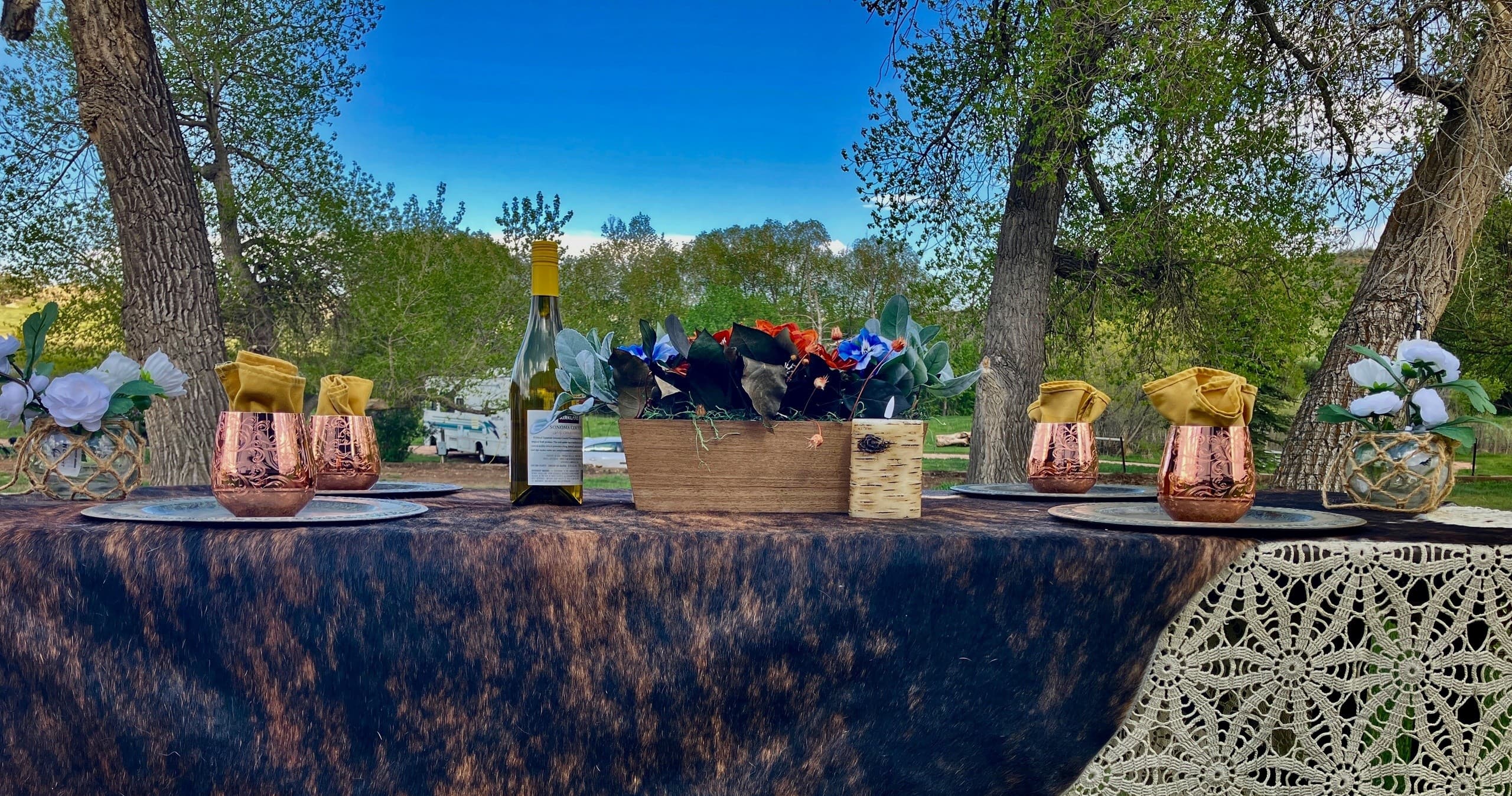 Outdoor rustic drink station with wine and copper mugs