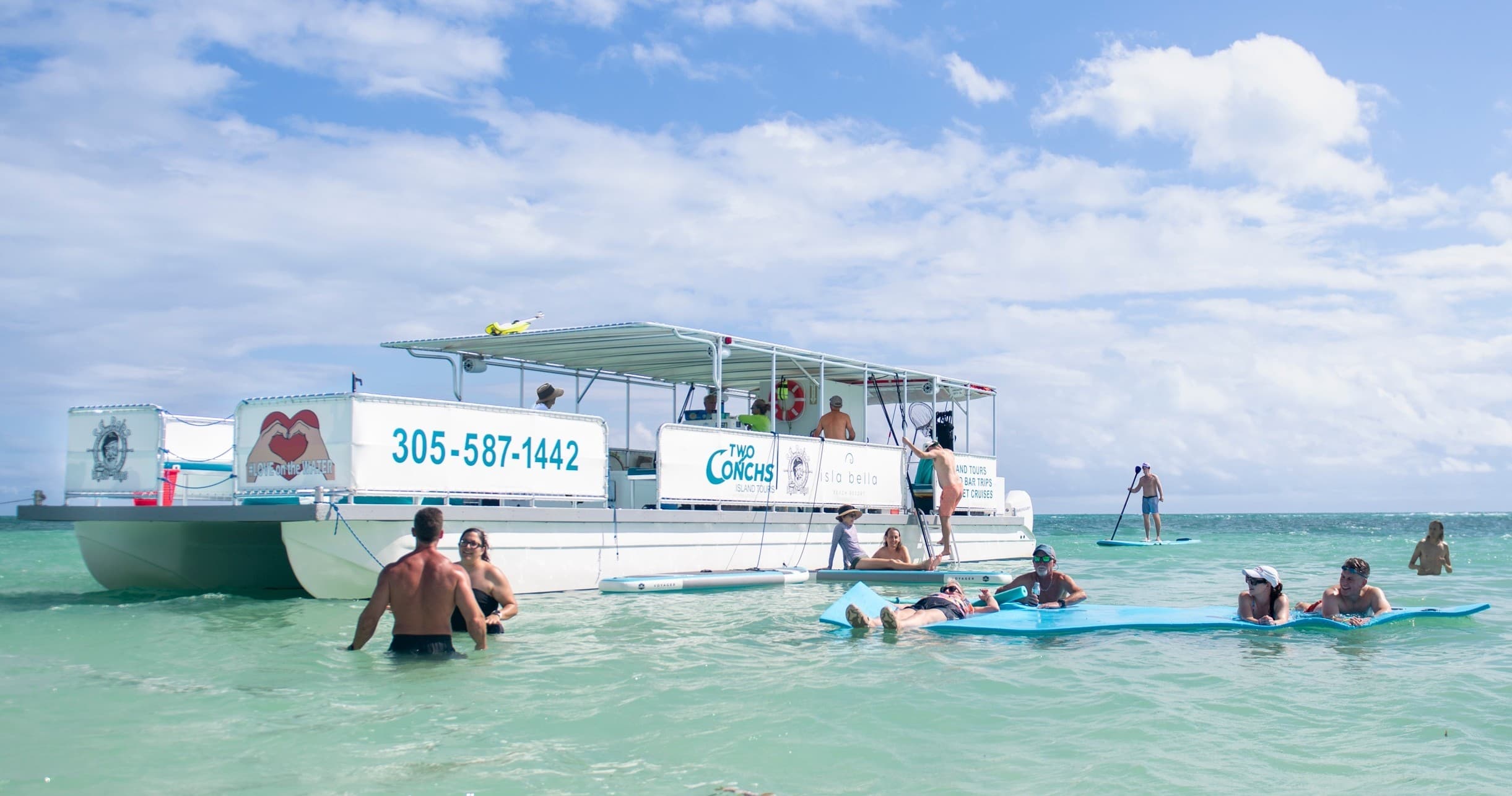 Passengers enjoying shallow snorkeling and boat tour in turquoise sea