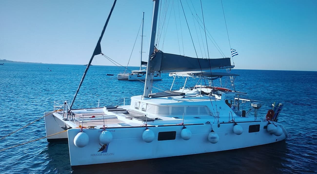 Luxury catamaran cruising calm azure sea, day sailing tour