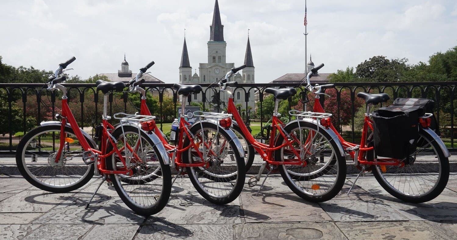 Red rental bikes lined near St. Louis Cathedral in New Orleans