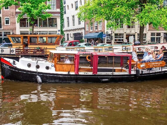 Discover Amsterdam’s Iconic Canals on an Intimate Small Group Electric Boat Cruise