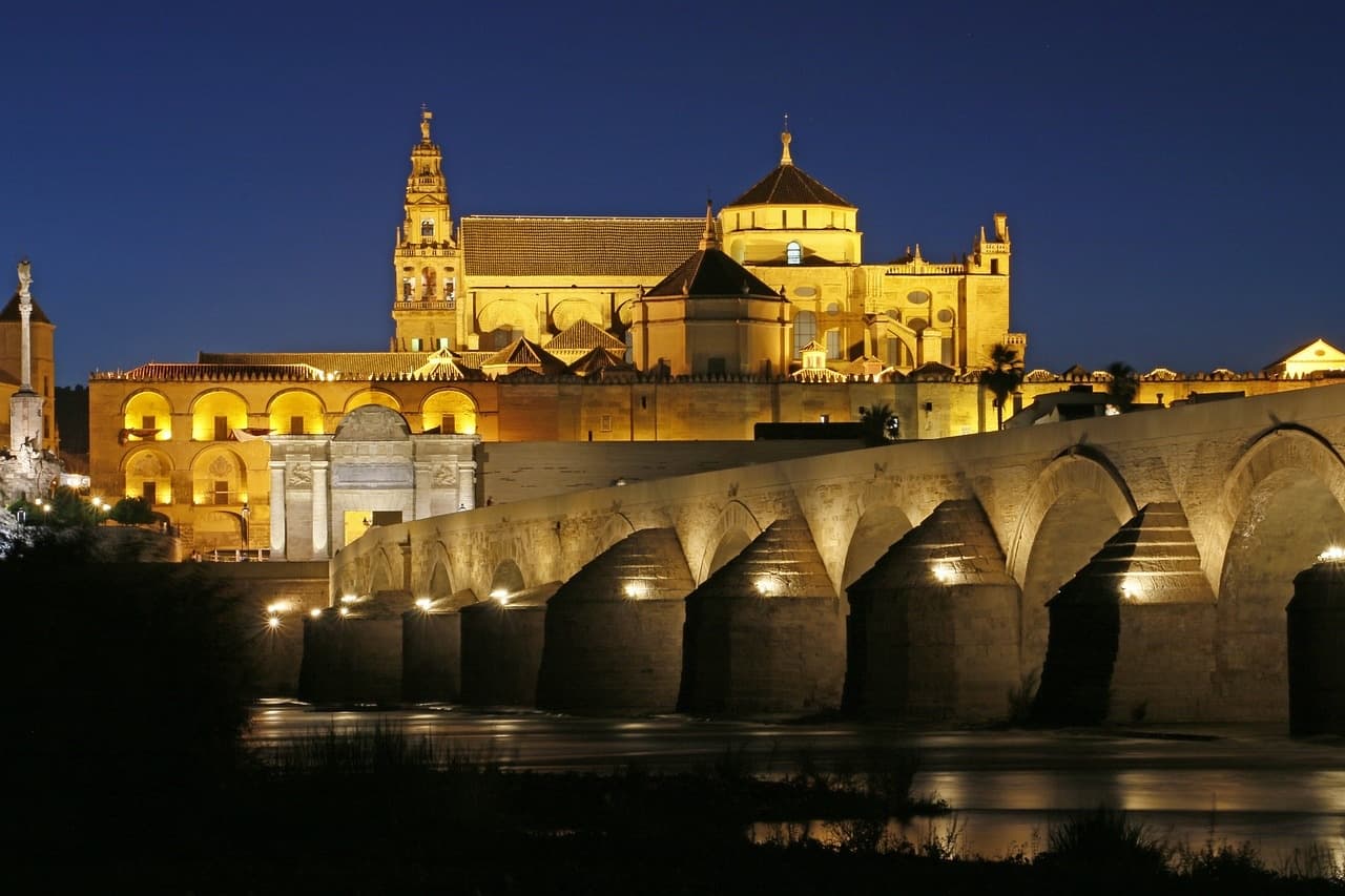 Night view of Mezquita-Catedral and Roman Bridge over Guadalquivir