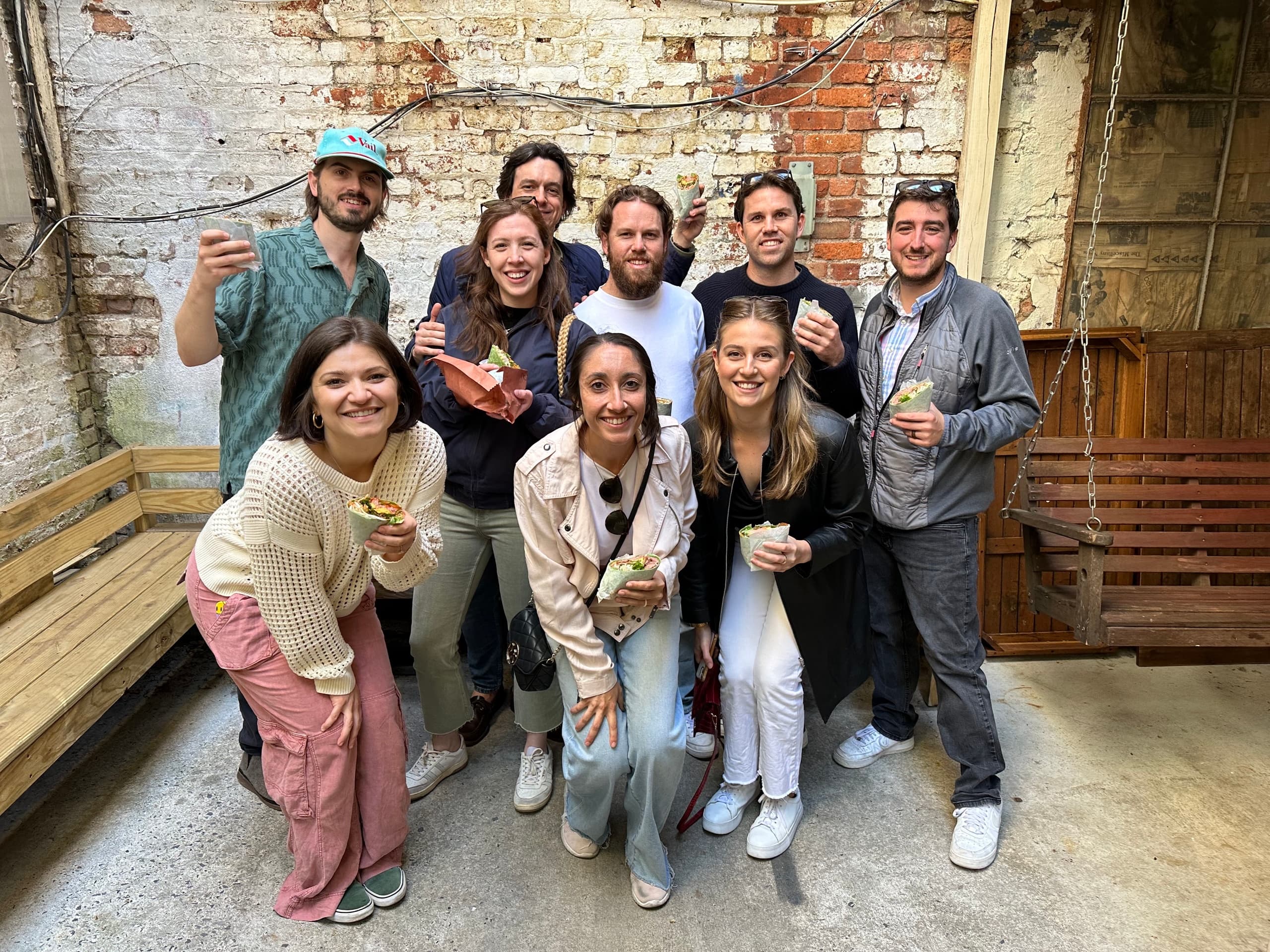 Group enjoying desserts in brick courtyard, casual outdoor gathering