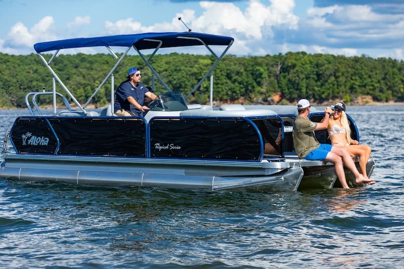 Friends on pontoon boat enjoying summer lake boating experience
