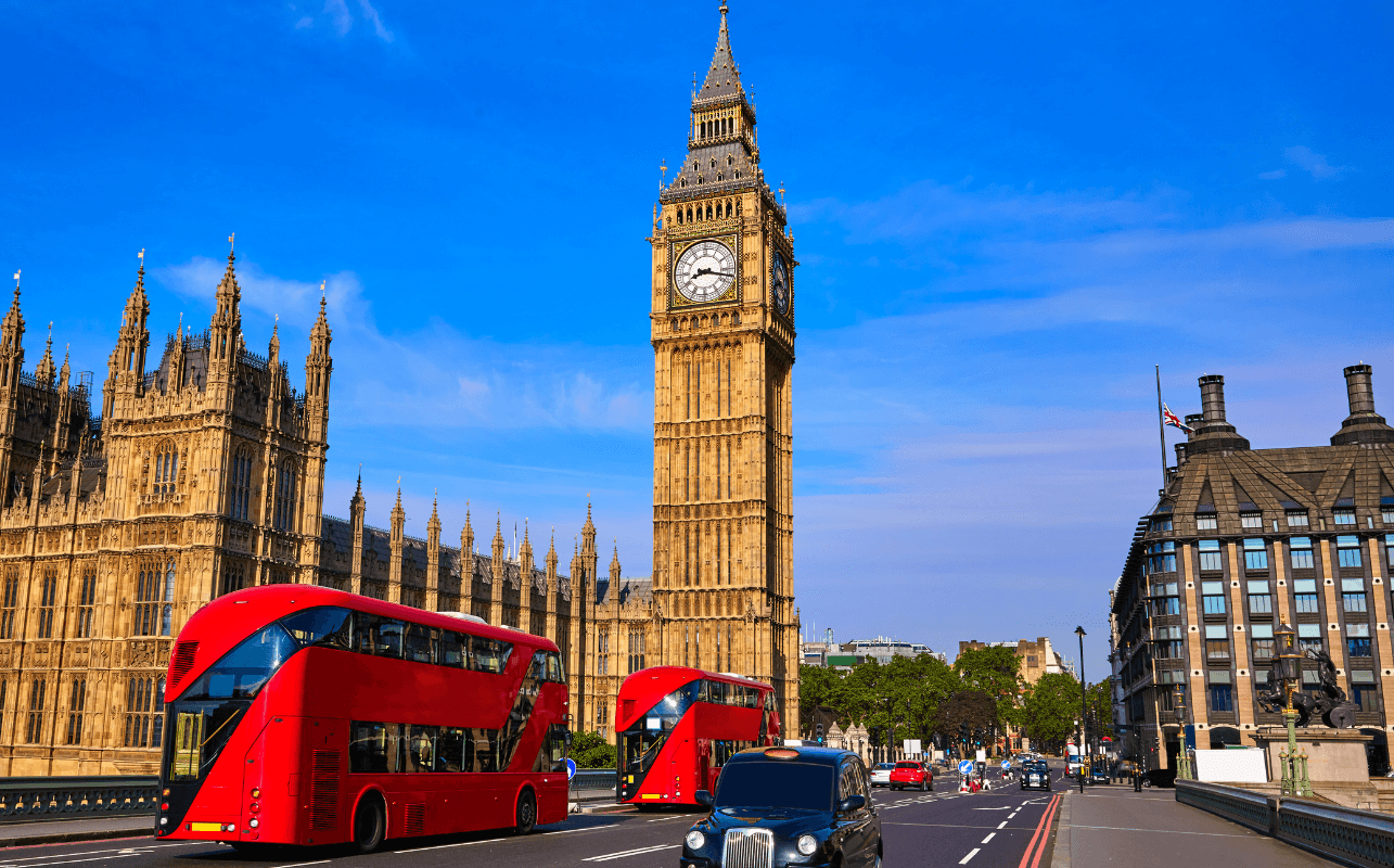 Red double-decker buses passing Big Ben and Westminster in London
