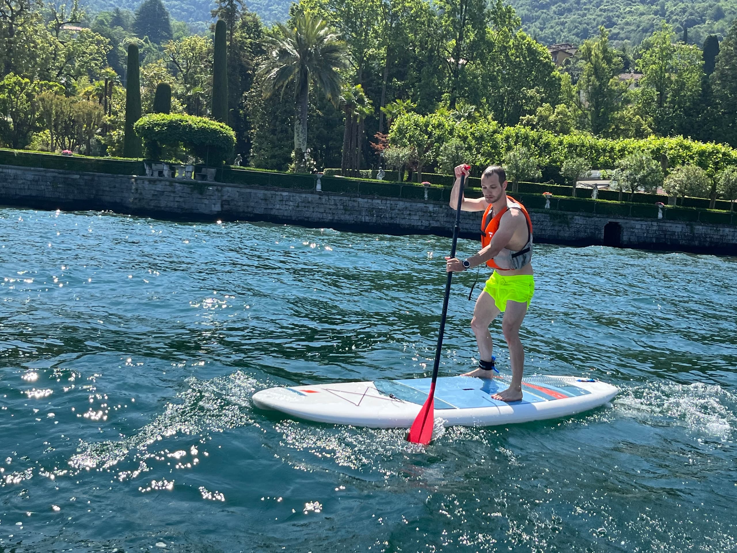 Paddleboarder on Lake Como enjoying bright sunny waters