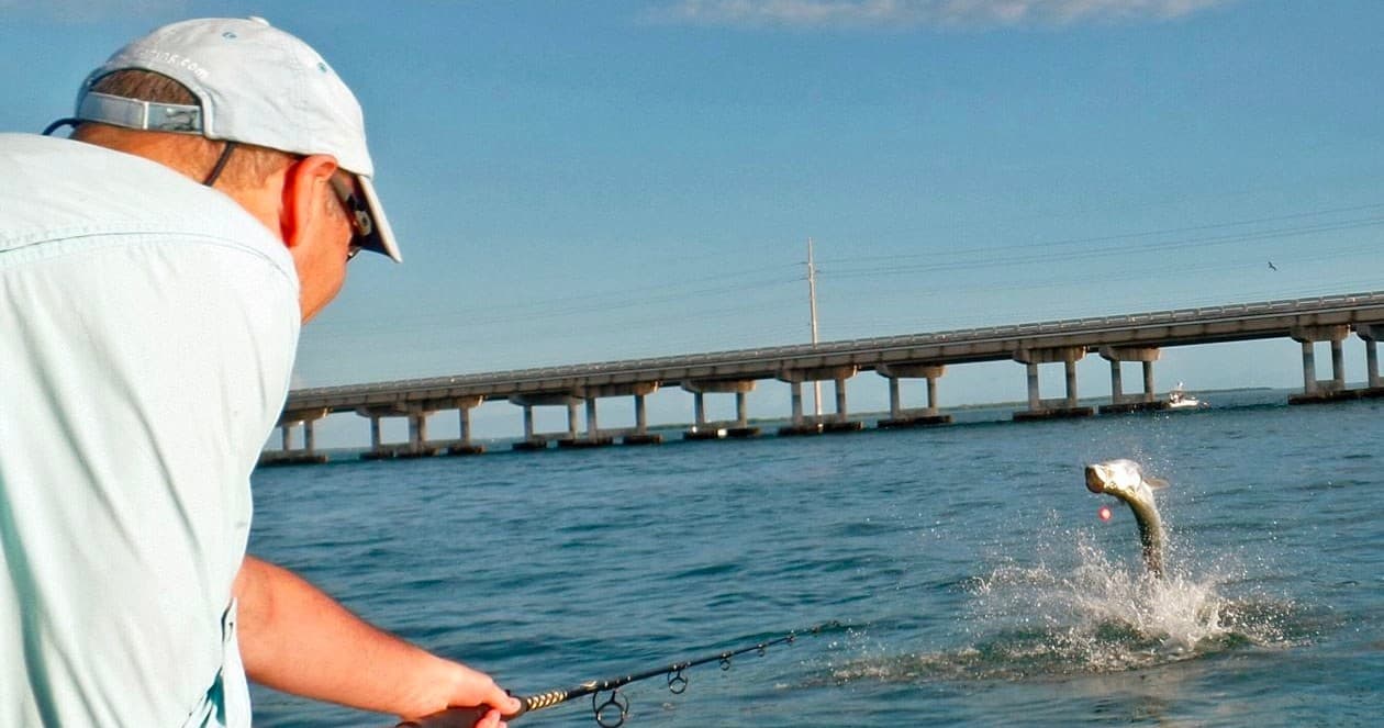 Angler casting near Bahia Honda bridge tarpon fishing action