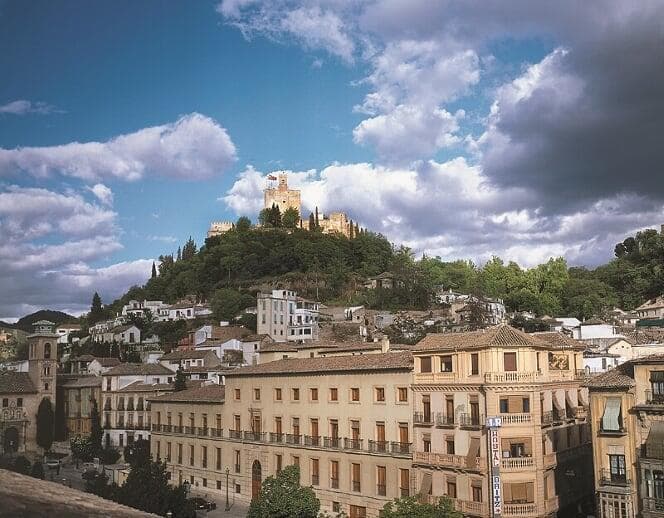 Scenic Granada hilltop city view with castle and rooftops