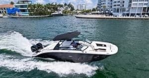 Powerboat speeding across coastal bay on sunny day
