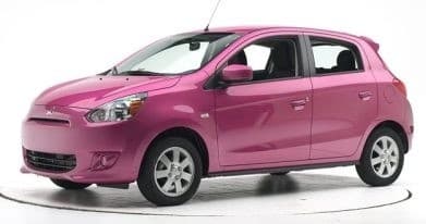 Pink compact hatchback rental car on white studio background
