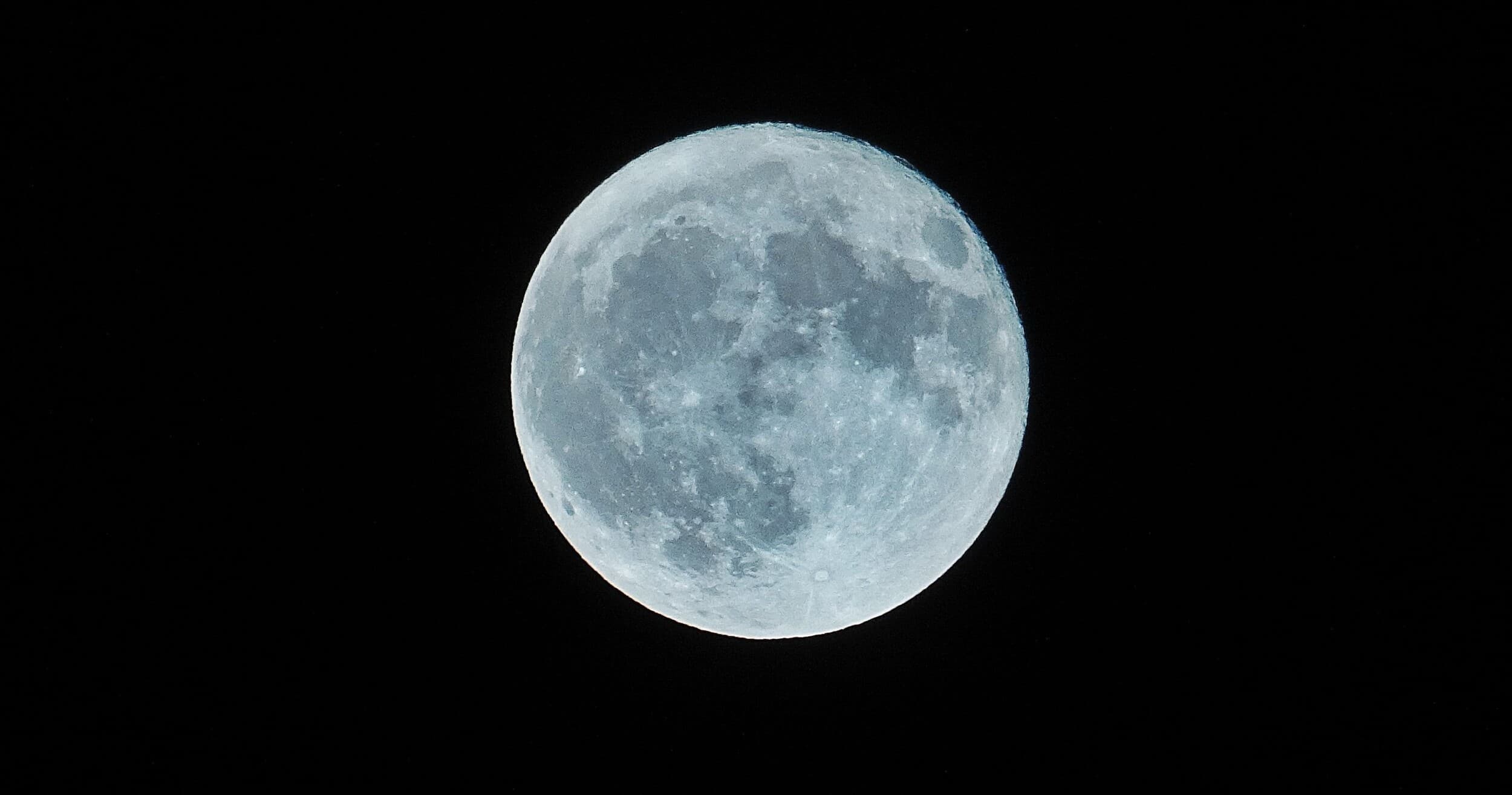 Full moon over black sky for night sky viewing and astronomy