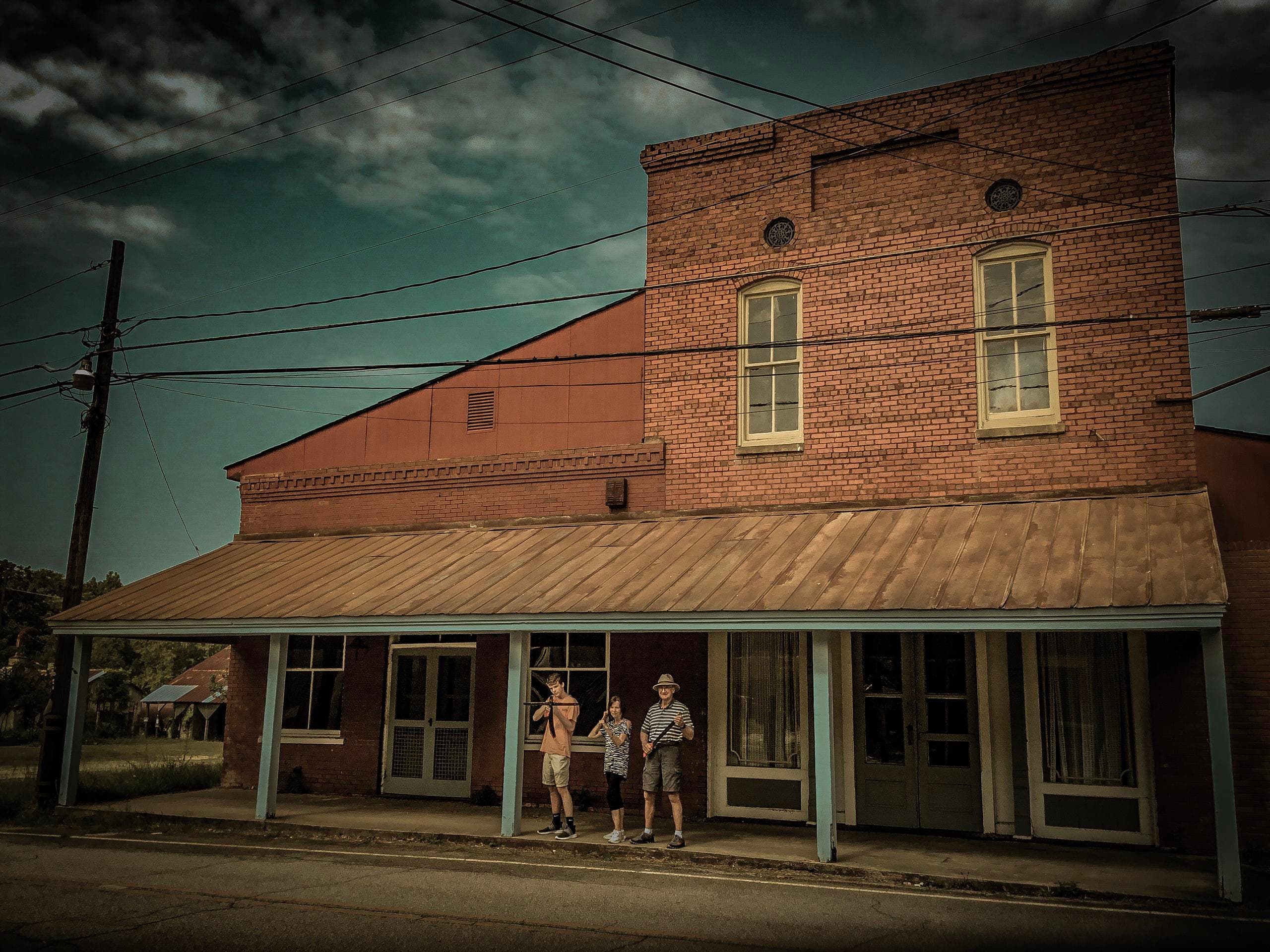 Historic downtown brick storefront with guided outdoor tour group