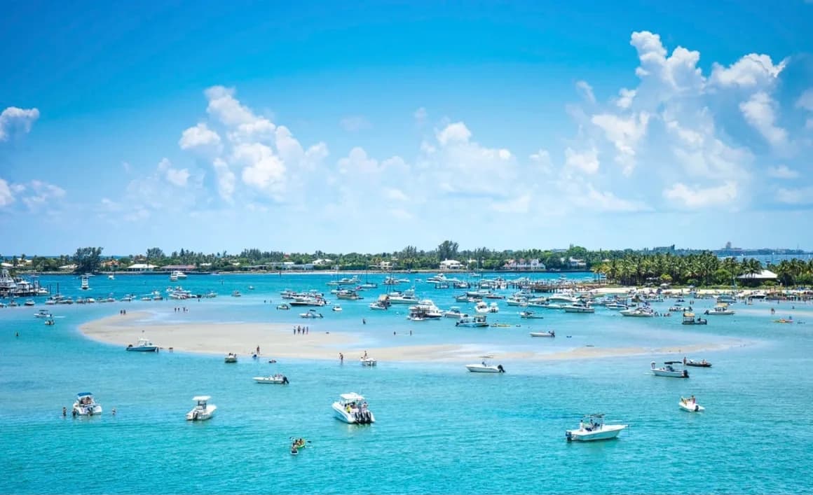 Boats clustered in a turquoise tropical bay, coastal boating fun