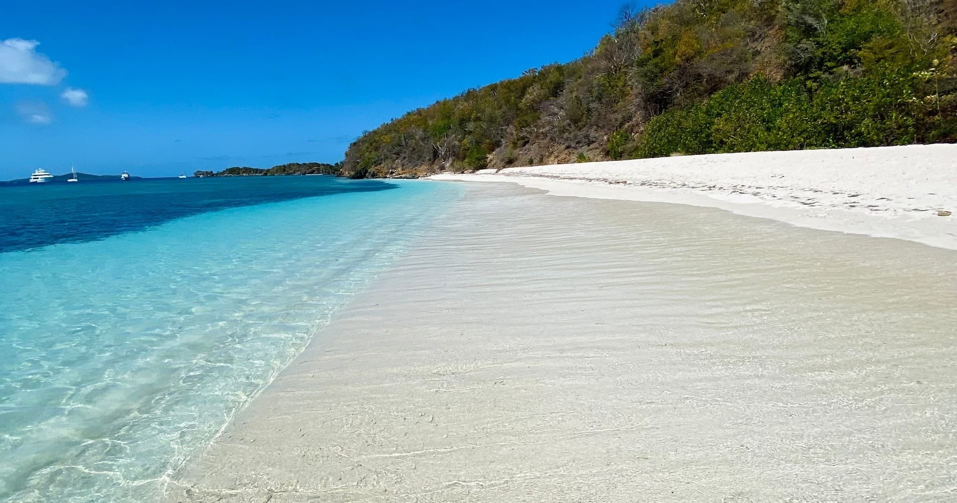 Pristine white-sand beach with turquoise shallows in Caribbean