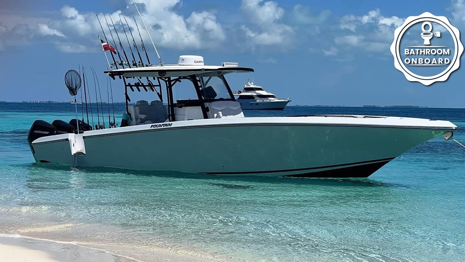 Center-console fishing boat anchored in clear tropical water