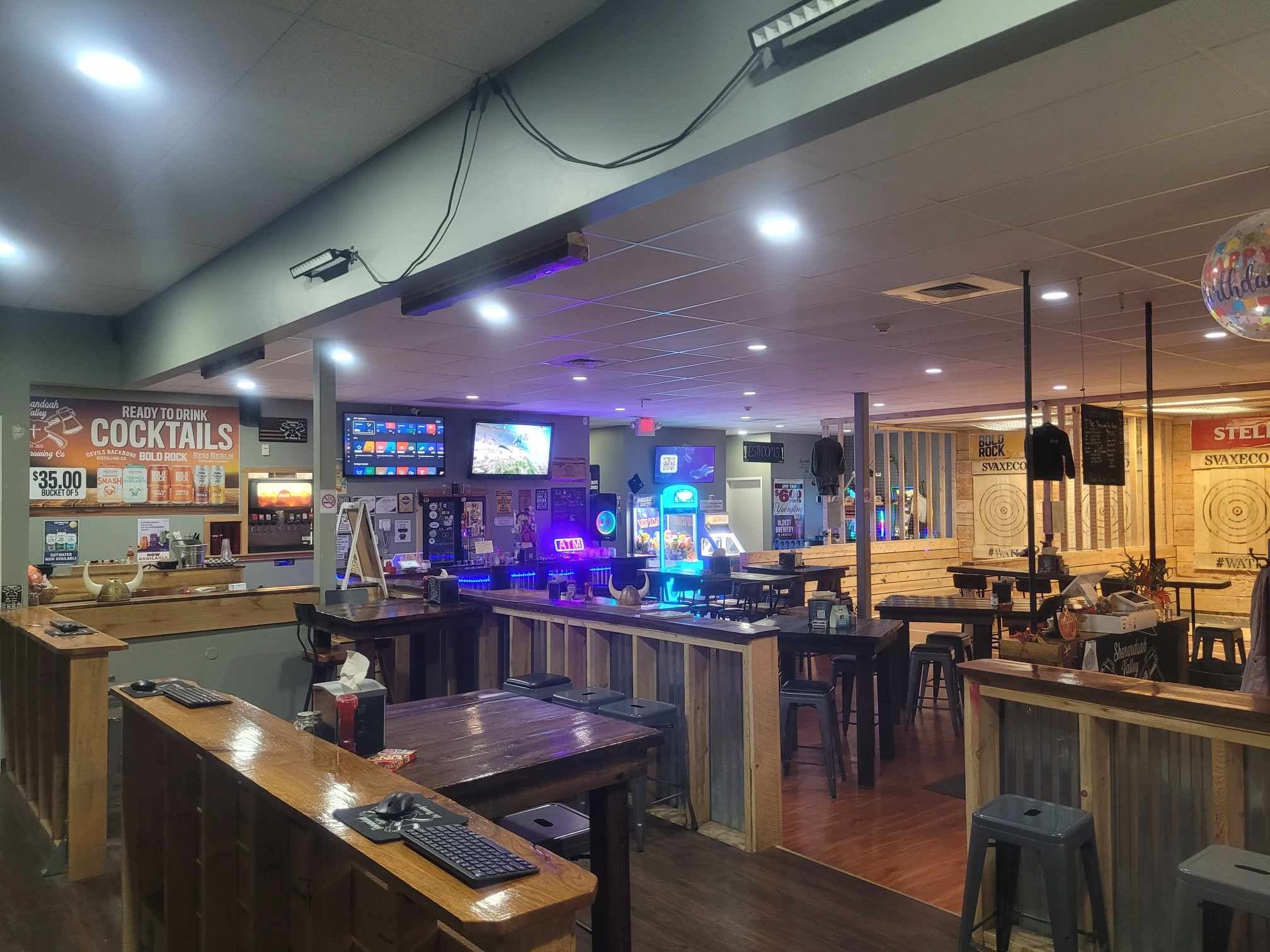 Axe-throwing bar interior with lanes, targets, and seating