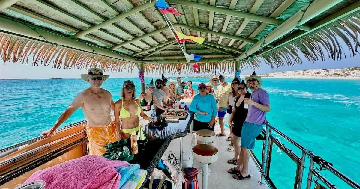 Open deck boat cruising turquoise tropical waters under thatch