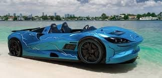 Sports car parked on tropical white sand beach beside turquoise sea