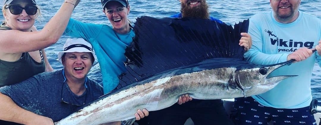 Charter wahoo fishing trip in open Atlantic waters, crew posing