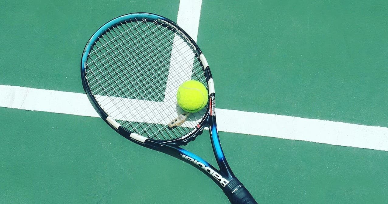 Tennis racket and ball on outdoor court at island resort