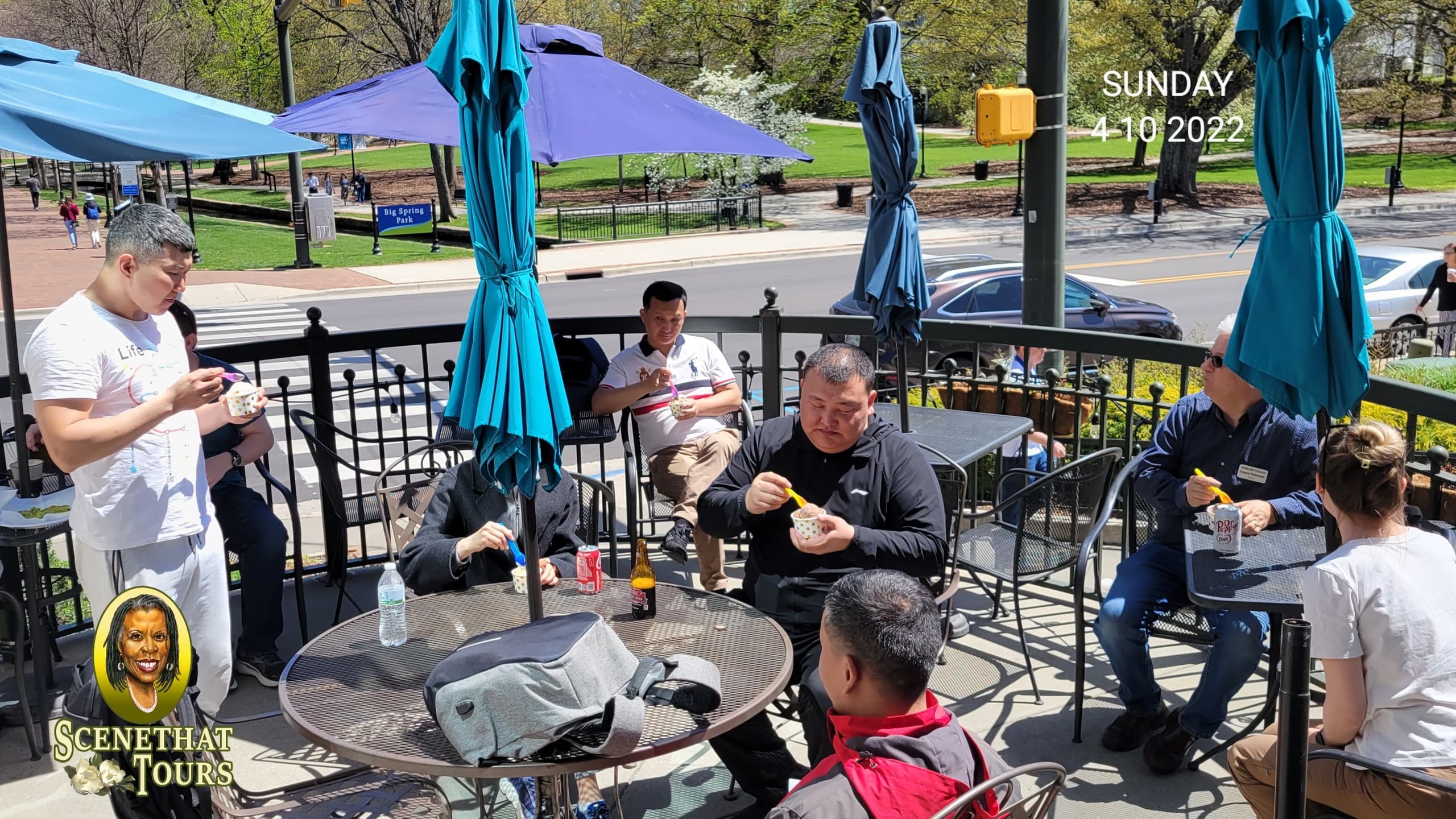 Outdoor cafe meetup with participants on sunny patio tour