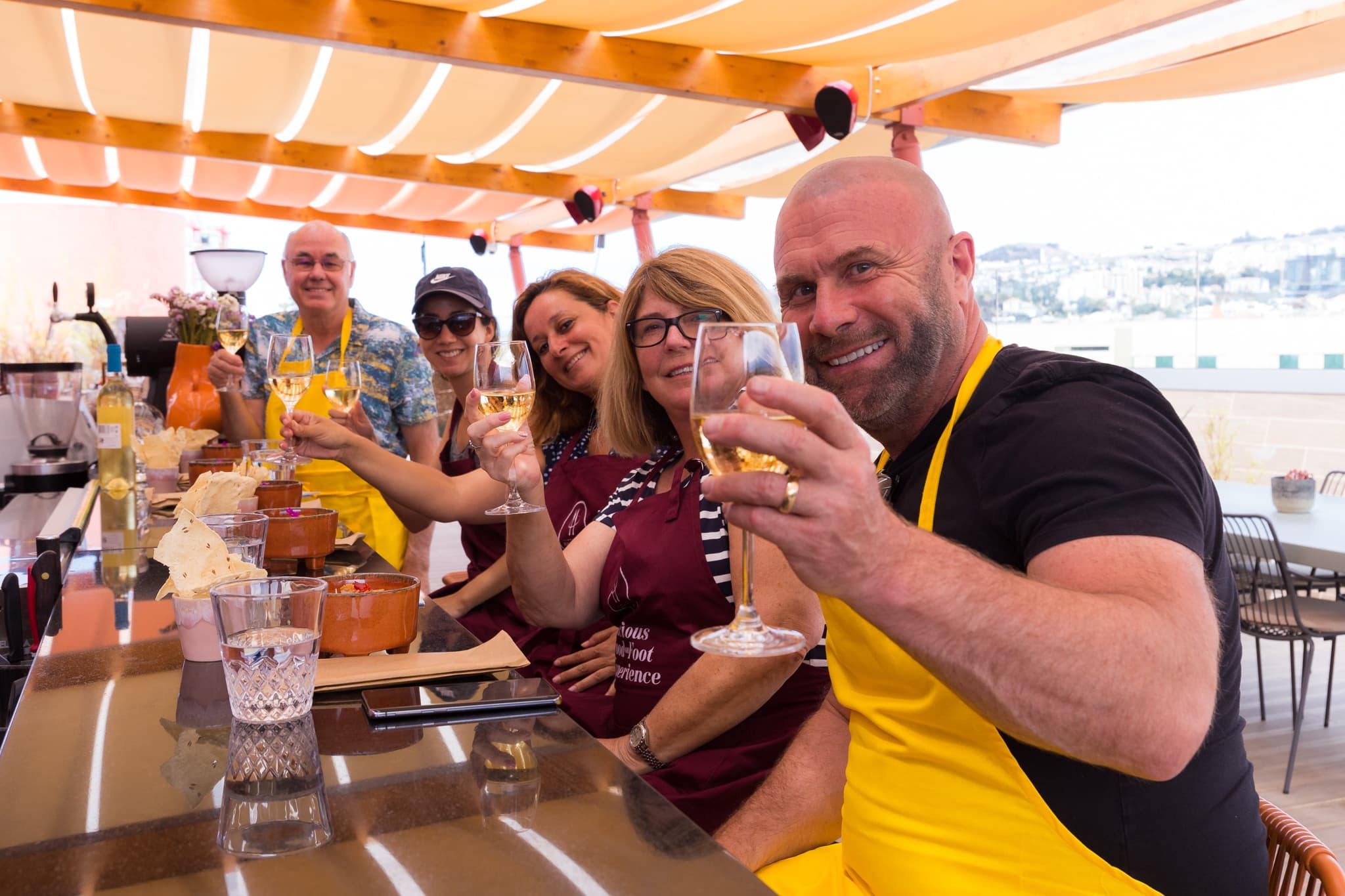 Group toasting at sunny seaside terrace restaurant in Madeira