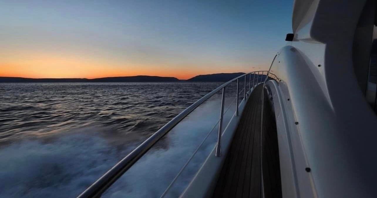 Sunset view from yacht deck cruising the Adriatic near islands