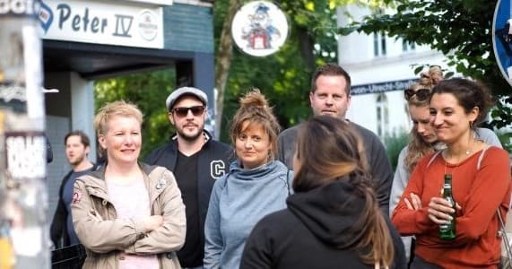 Small group on outdoor walking tour next to waterfront park
