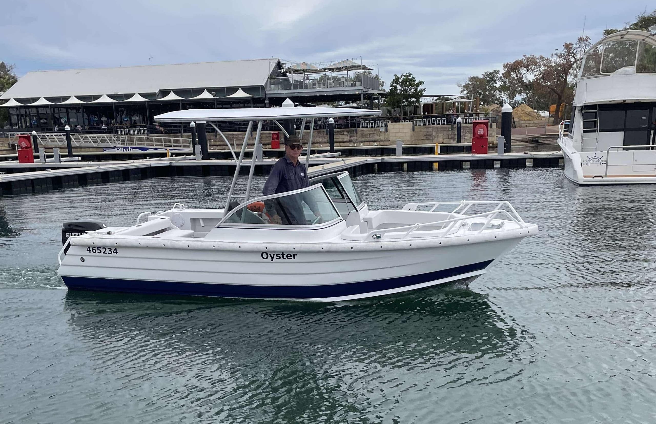 Motorboat cruising Marina waters with waterfront backdrop