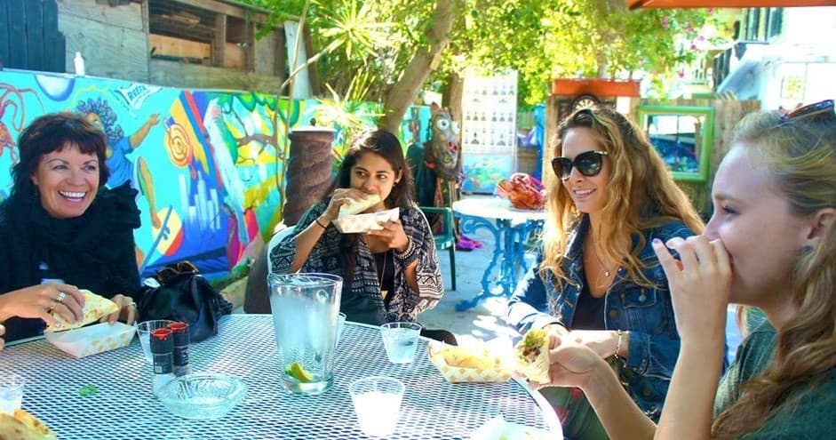 Guests enjoying outdoor Key West food tour at colorful patio