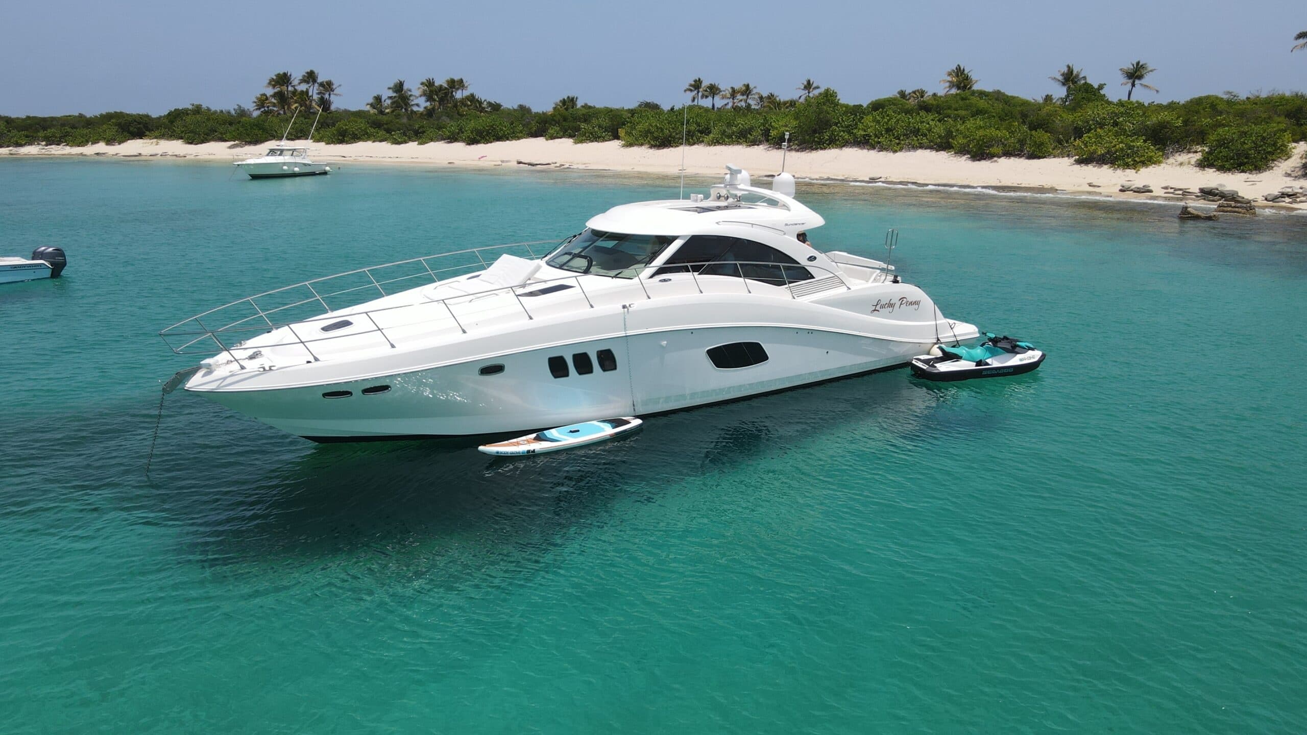 Luxury yacht anchored in turquoise Caribbean cove, scenic view