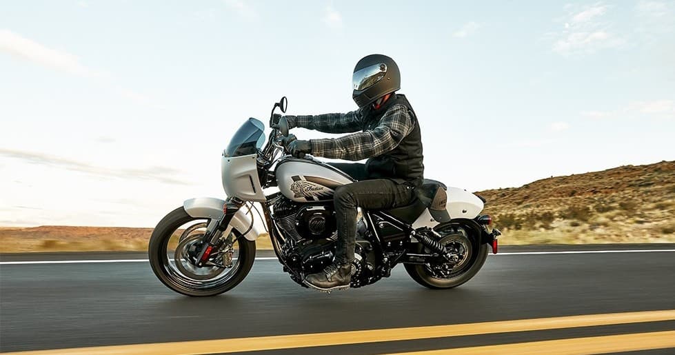 Motorcyclist riding scenic coastal highway through desert