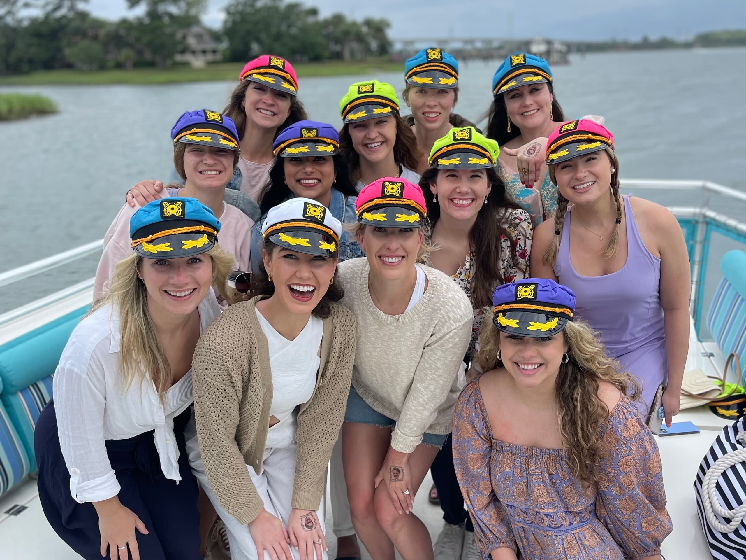 Group boat charter party on deck in open coastal waters