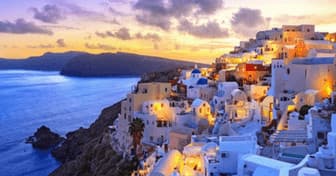 Twilight Santorini houses on cliffs overlooking Aegean Sea