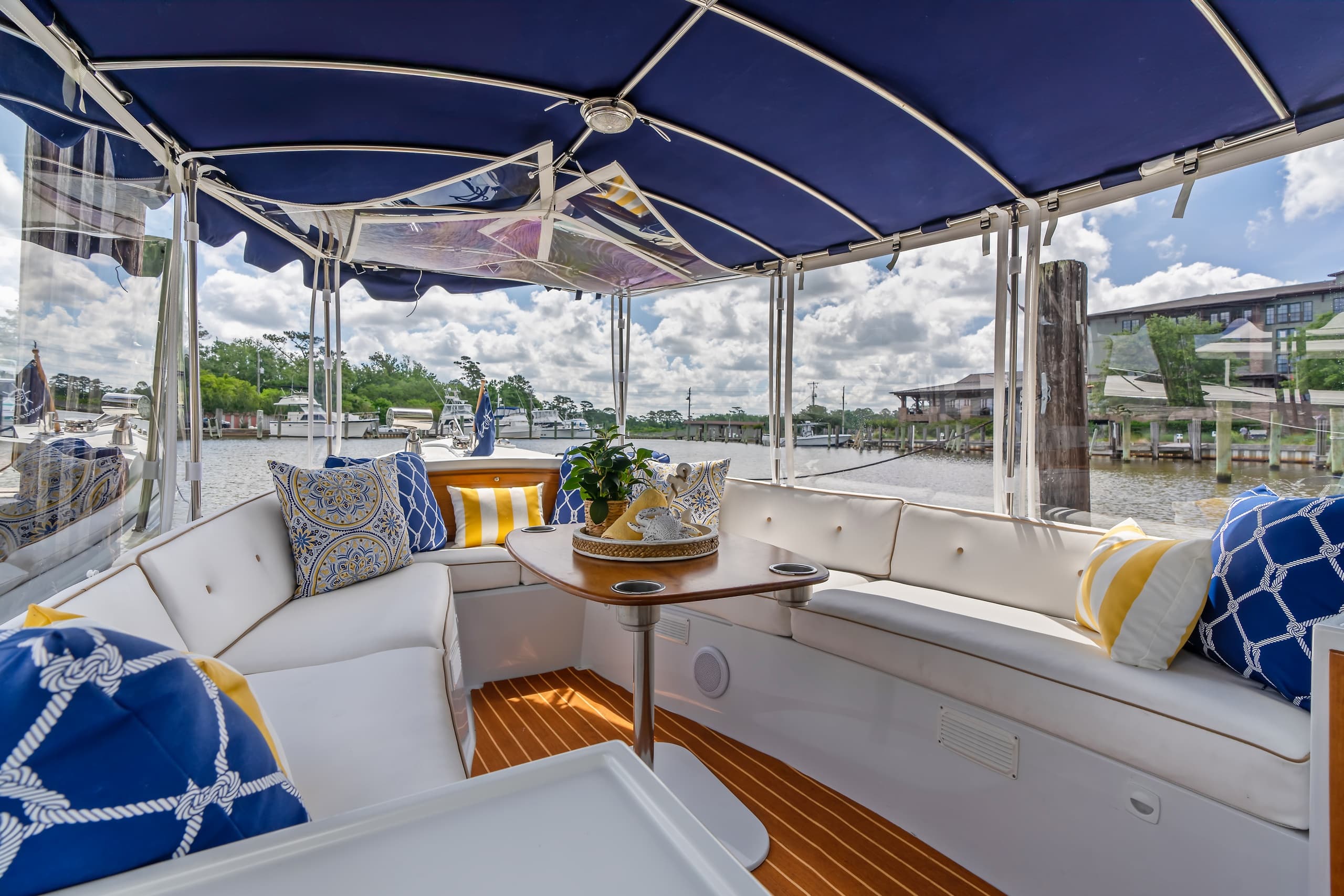 Covered boat cockpit seating with marina views for relaxing cruise