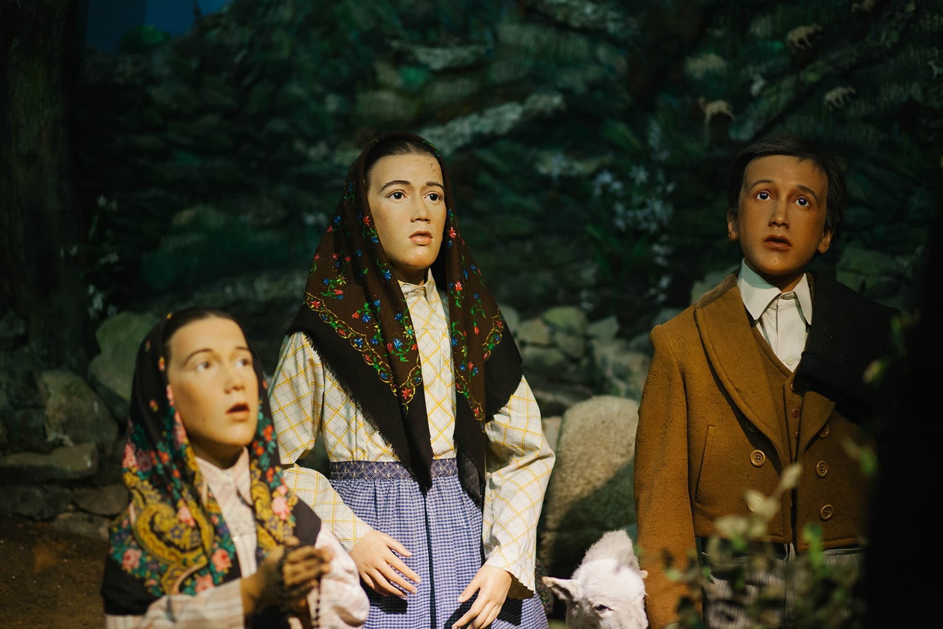 Museum diorama of villagers in forest setting, pastoral scene display
