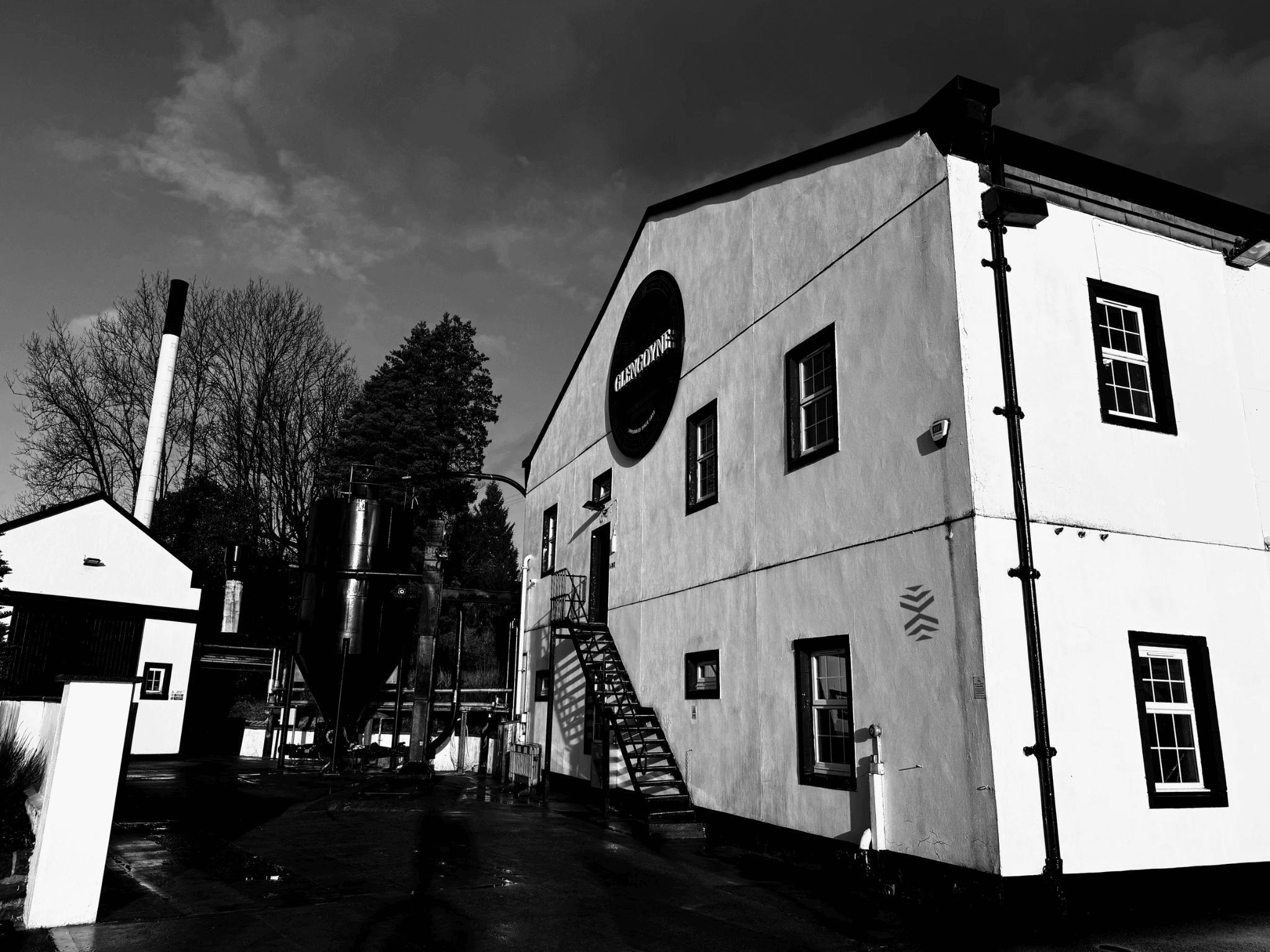 Historic Scottish distillery exterior with courtyard, outdoor tour